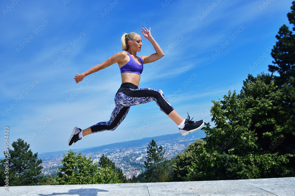 Young woman joyfully jumping in Park Young woman joyfully jumping in Park