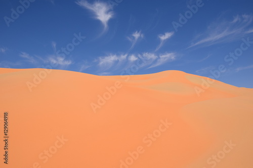 Fototapeta Naklejka Na Ścianę i Meble -  red sand dunes in desert with blue sky 