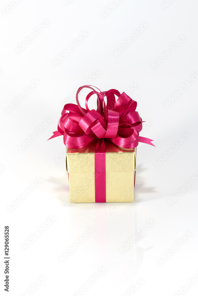 Gold gift box with red ribbon isolated on white background Gold gift box with red ribbon isolated on white background