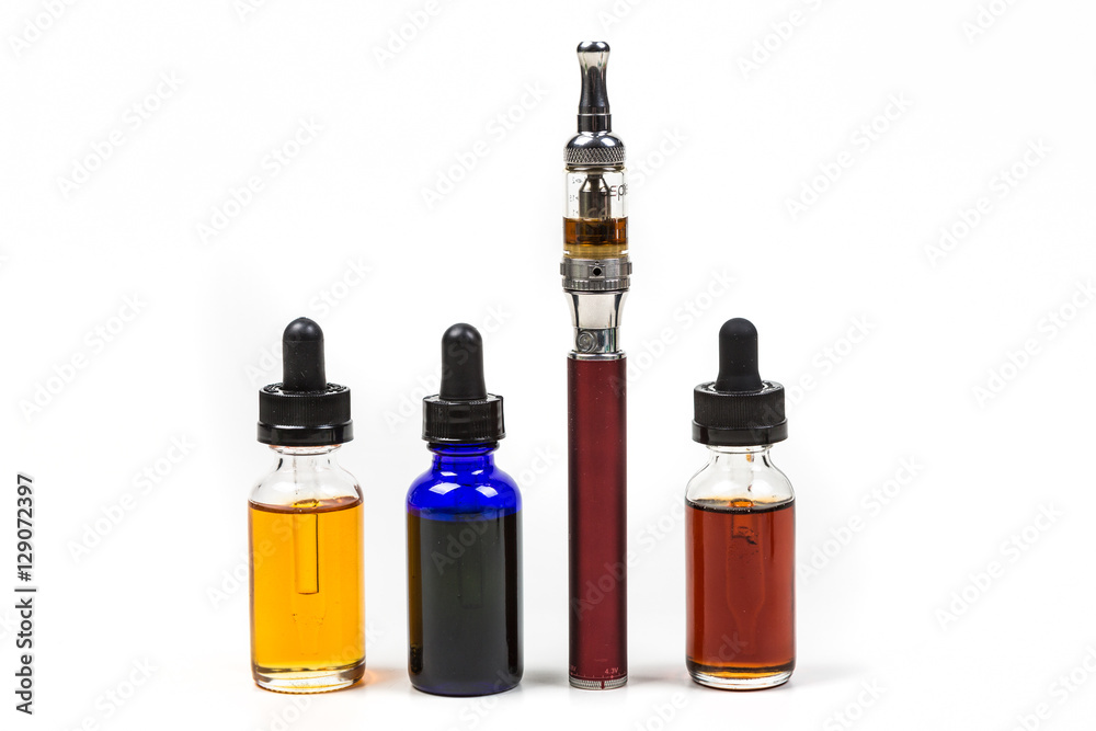 Flavored vape juice and ecigarette with shallow depth of field and objects out of focus isolated on white background Flavored vape juice and ecigarette with shallow depth of field and objects out of focus isolated on white background