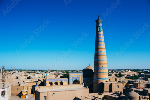 The architecture of Itchan Kala, the walled inner town of the city of Khiva, Uzbekistan. Khoja Minaret. UNESCO World Heritage photo