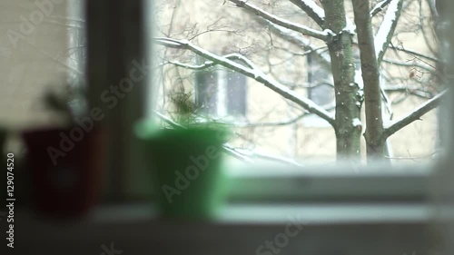 This video is about snow. on the snow from the windows of the house view. 4 fragments of falling snowflakes.