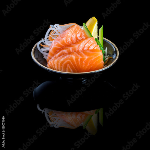 sashimi with tuna in a black plate. On a black background.