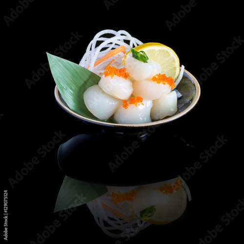 sashimi with tuna in a black plate. On a black background.