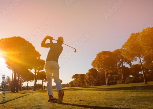 golf player hitting shot with club