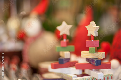 christmas wooden toys in the form of folding pyramid and star on a blurred background