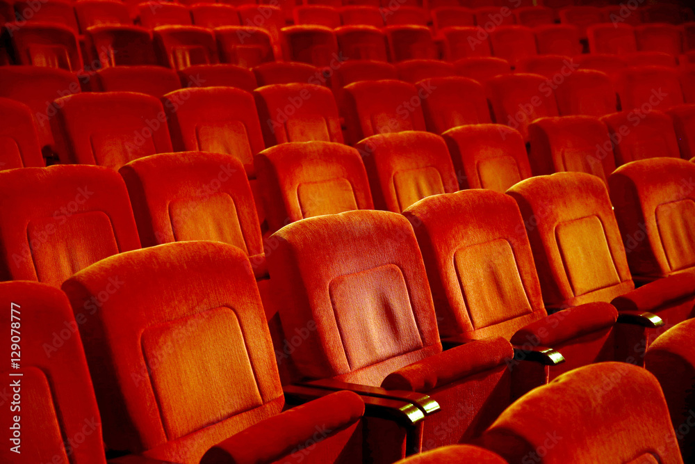 Interiors empty reddish cinema chairs seats in low-key indoors Interiors empty reddish cinema chairs seats in low-key indoors