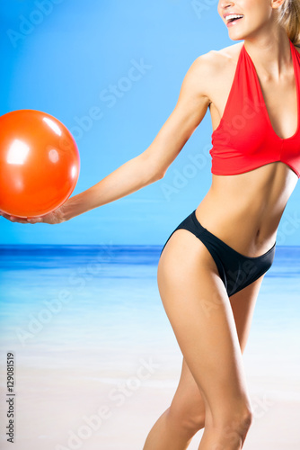 woman in swimwear playing with ball