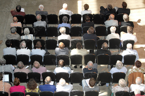 Unknown business people sitting and listening on scientical presentation photo