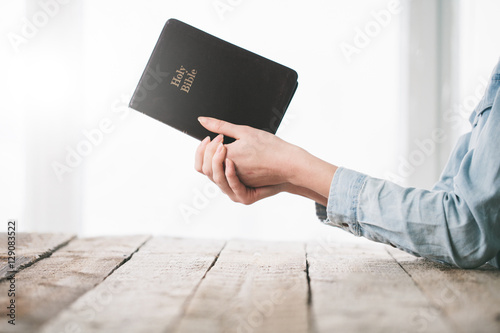 Valokuvatapetti Woman reading and praying over Bible