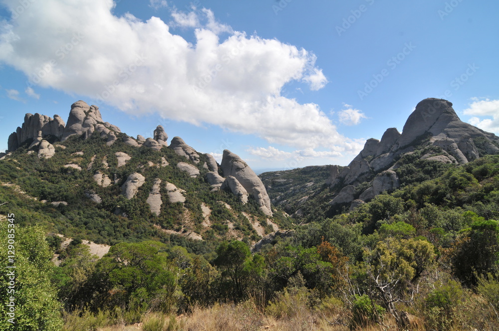 Montserrat  - multi-peaked rocky range located near the city of Barcelona in Catalonia, Spain.
