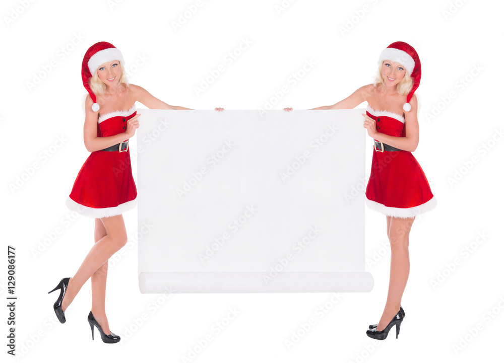 Two happy cute Santa women with christmas poster isolated on white background Two happy cute Santa women with christmas poster isolated on white background