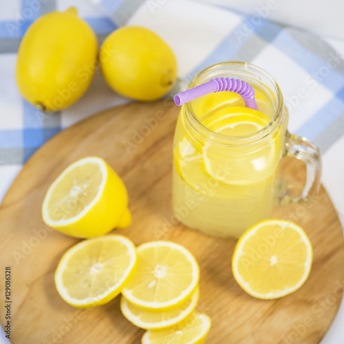 Lemonade in a transparent cup with handle