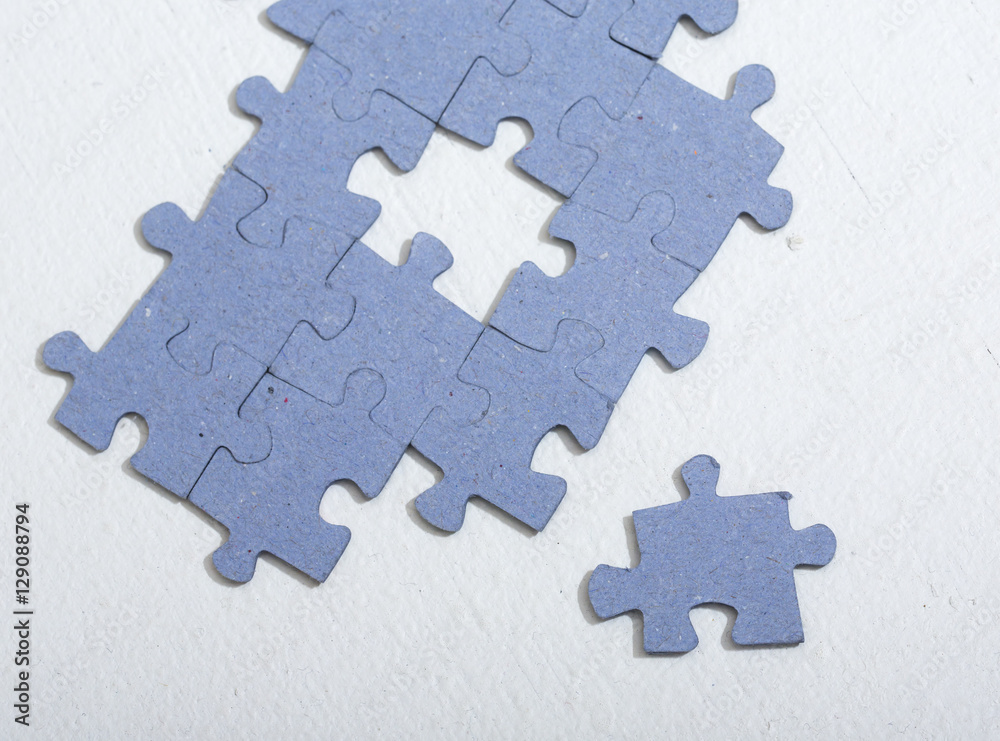 Puzzle pieces on a white table. Puzzle pieces on a white table.