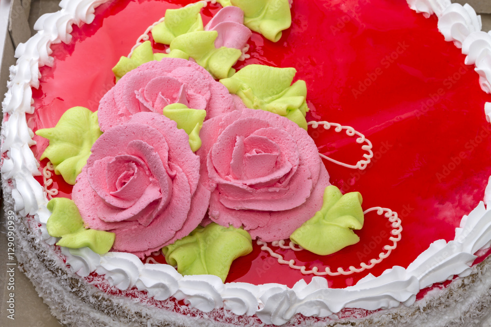 Pink roses of cream on the cake