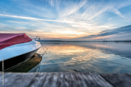 Wall Mural Boat near to a pier at sunset time