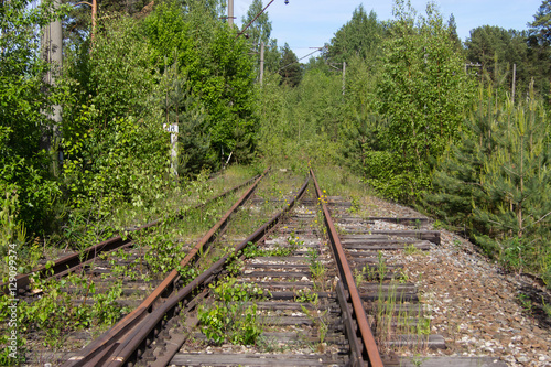 Old rusty railway tracks with wooden sleepers