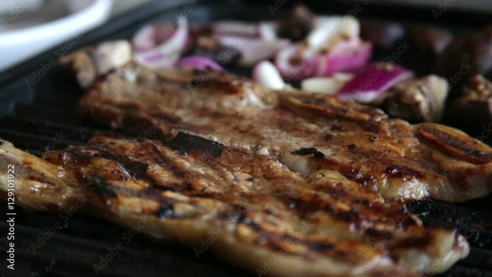 Grilling Marinated Korean Short Ribs. Meat on the Grill with Sizzle and Smoke Steam.