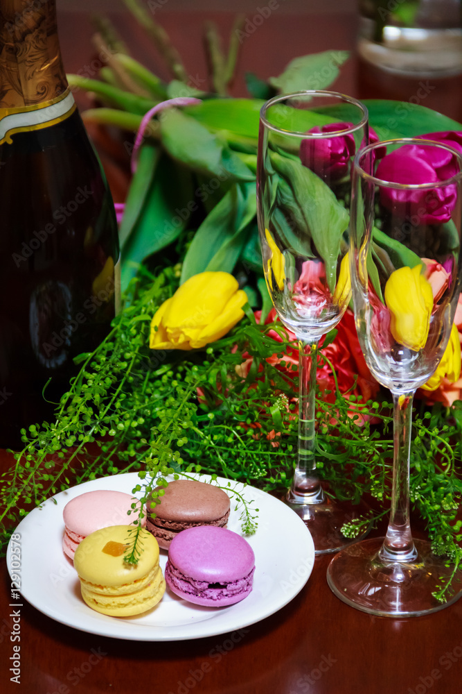 Macaroons on a plate with a bunch of flowers