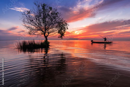 Photography Fishermen on a boat in the lake at sunrise beautiful sky