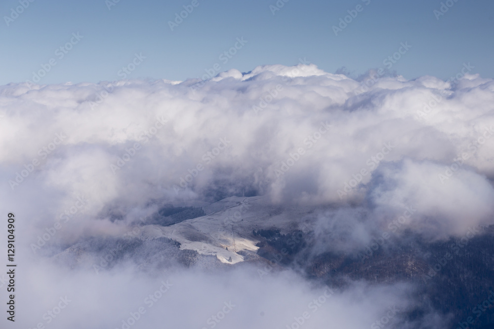Beautiful blue sky background with clouds and mountains with sno