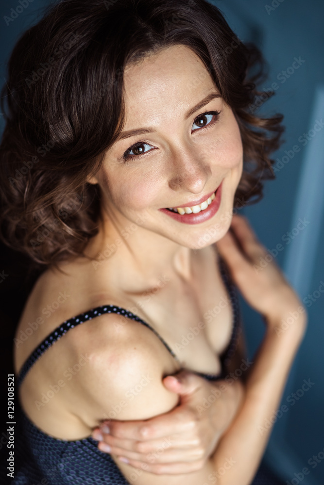 Tender young woman in a black dress with natural makeup and hairstyle Tender young woman in a black dress with natural makeup and hairstyle