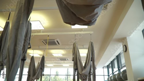 Slow motion, hammocks for hanging fly yoga in a beautiful gym, slidecam photo