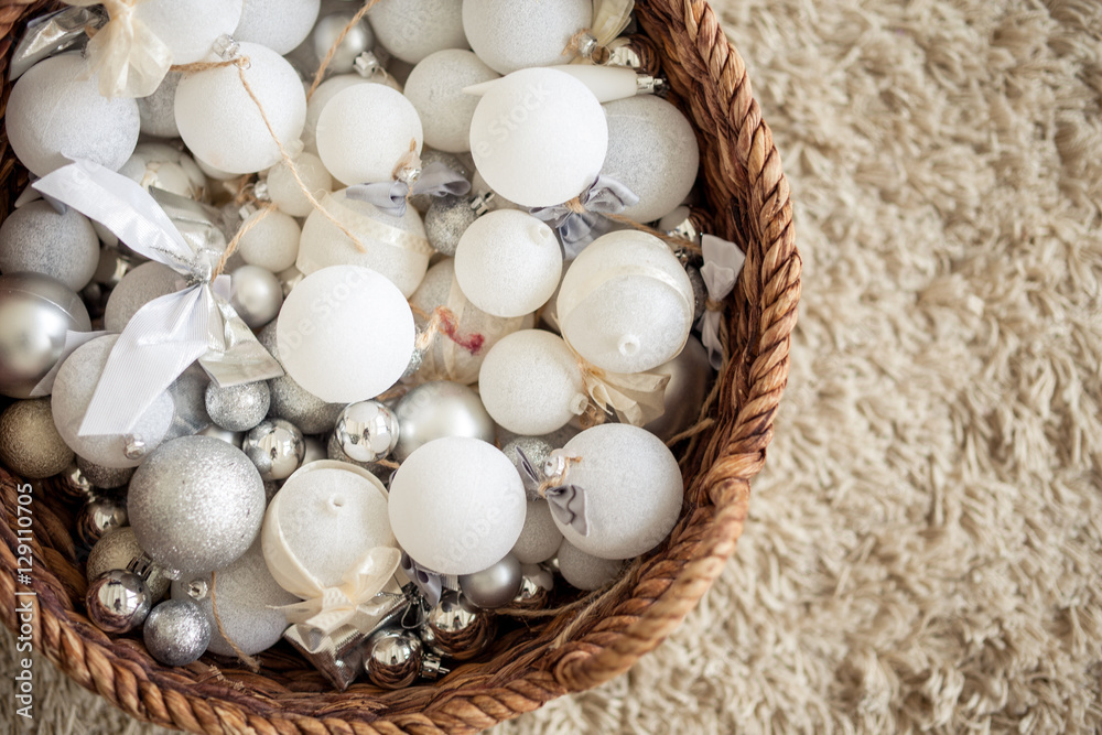 Basket Full of Christmas balls. On a warm beige carpet we see a full basket of Christmas balls. Basket Full of Christmas balls. On a warm beige carpet we see a full basket of Christmas balls.