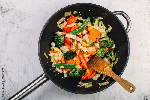 Tasty vegetable dish with broccoli and colorful peppers cooked in oil stained asian wok recipe 