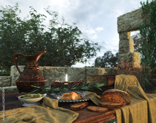 Fototapeta stilllife on nature background with ancient ruins, books,bread olive and pitcher