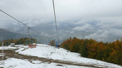 The descent from the mountain on the chair lift. Mountain autumn landscape