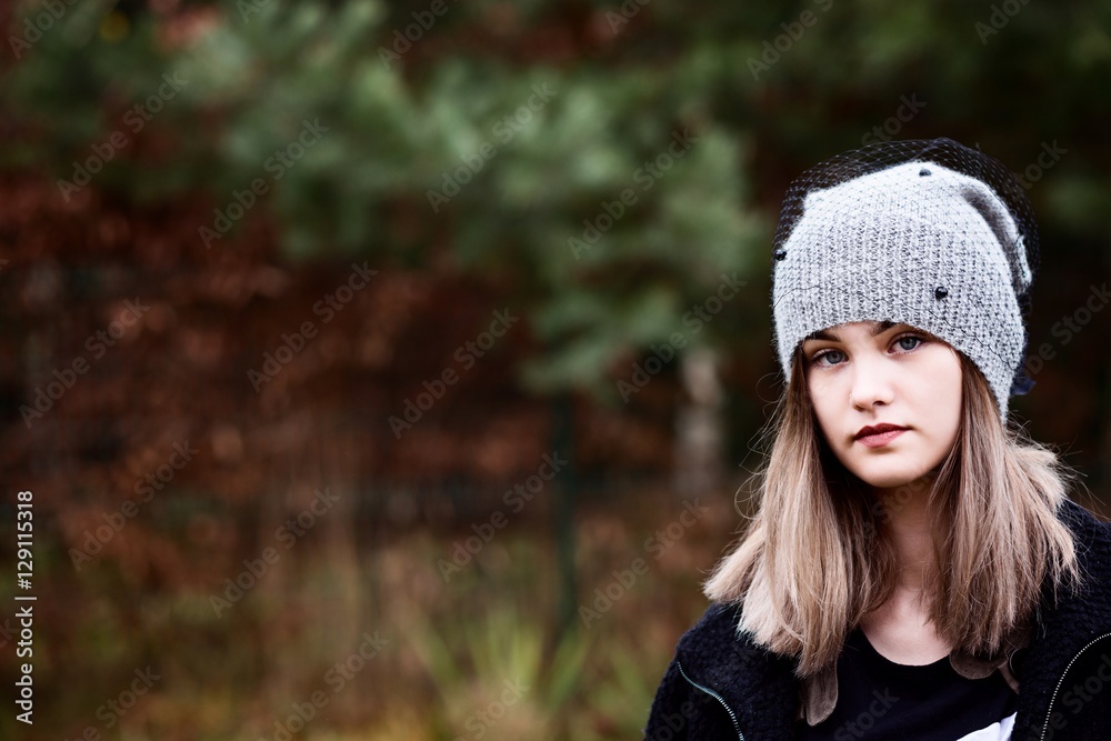 Thoughtful young woman in woolen grey cap Thoughtful young woman in woolen grey cap