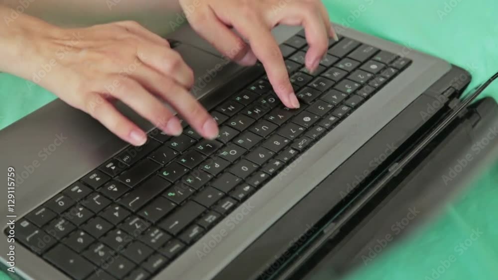 Woman's hands typing on a laptop keyboard. Business, communication, freelance and internet concept Woman's hands typing on a laptop keyboard. Business, communication, freelance and internet concept