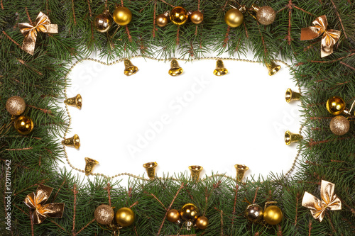 Christmas frame made of fir branches decorated with balls bells and bows isolated on white background