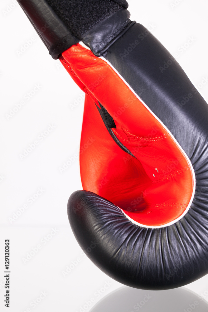 Red and black boxing gloves on a glass table