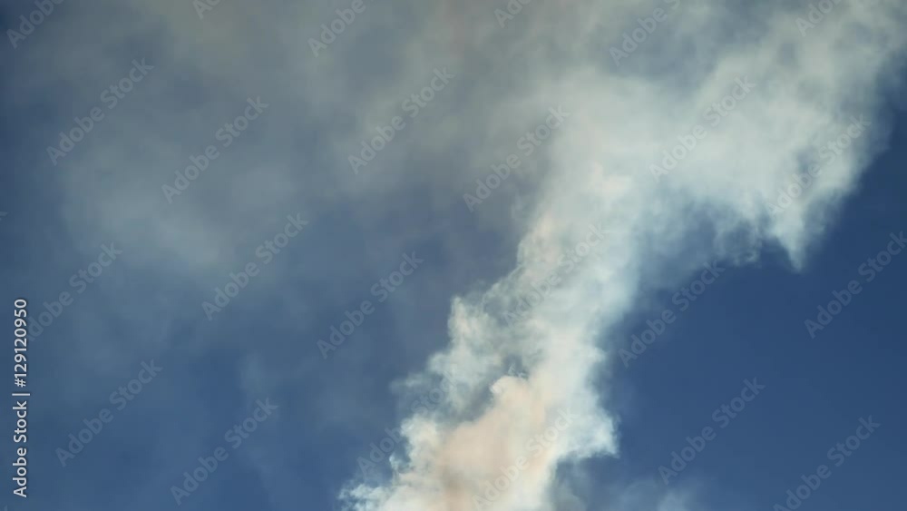 white smoke against a blue cloud sky sunlight nature landscape white smoke against a blue cloud sky sunlight nature landscape