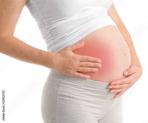 Pregnant woman with abdominal pain on white background © Africa Studio