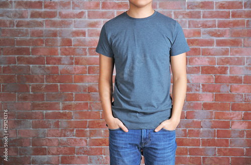 Young man in blank grey t-s...