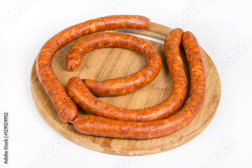 Raw homemade domestic sausage on the wooden board. Flat lay with