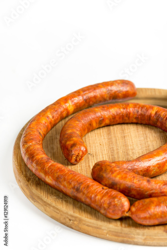 Raw homemade domestic sausage on the wooden board. Flat lay with