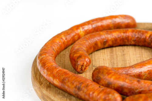 Raw homemade domestic sausage on the wooden board. Flat lay with
