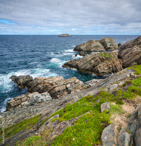 Cape Bonavista featuring coastal slabs of stone boulders and rocks that show their layers of formation over millions of years.  Rocky boulder shoreline in Newfoundland  Canada.