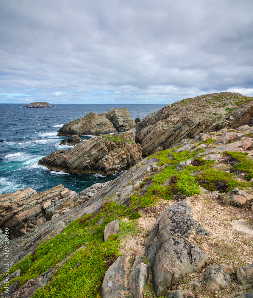 Cape Bonavista featuring coastal slabs of stone boulders and rocks that show their layers of formation over millions of years.  Rocky boulder shoreline in Newfoundland, Canada.