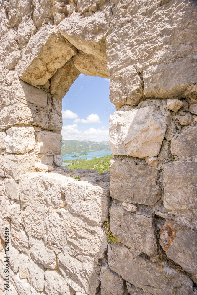 The view through a window in the restored Walls of Ston, known as the European Great Wall of China, towards the township of Mali Ston, in the south of Croatia.