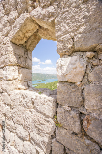The view through a window in the restored Walls of Ston, known as the European Great Wall of China, towards the township of Mali Ston, in the south of Croatia.