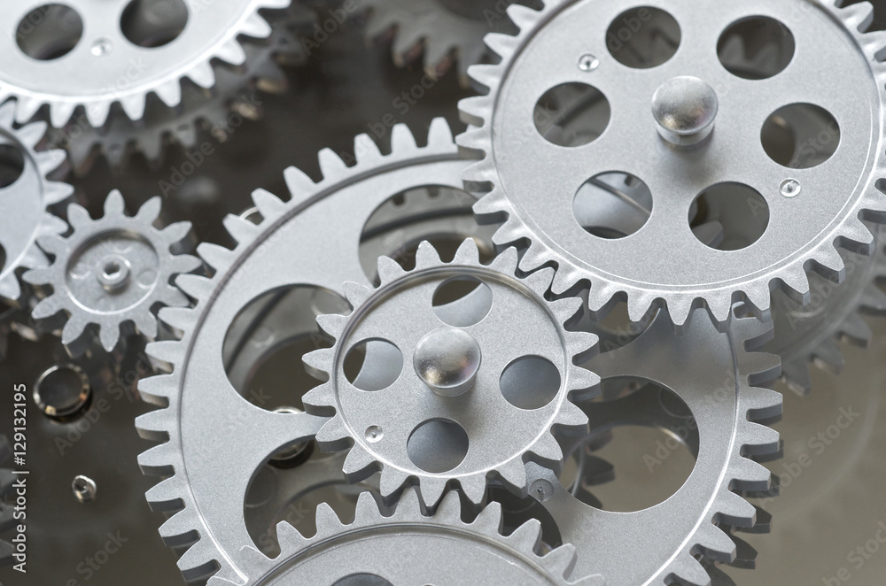 Silver Gears Working Together And Interlocked Silver Gears Working Together And Interlocked