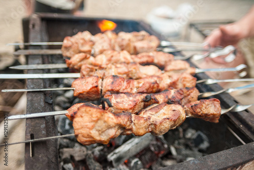 Kebabs on skewers over charcoal on the outside