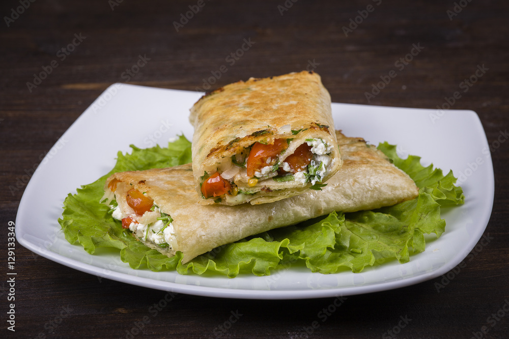 Pita bread wrapped with cottage cheese and vegetables.