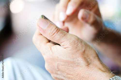 Close up of older man checking his phone background