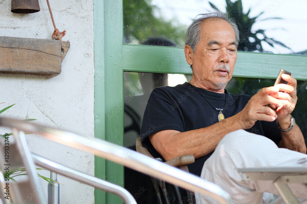 senior man enjoying on his phone senior man enjoying on his phone